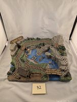 Full view of the 3D Summit Trail cribbage board showing hiking trail, water, bridges, cabin, and trees.