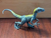 Side profile of Jurassic World Velociraptor figure showing detailed paint and texture