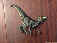 Side view of articulated Velociraptor Delta figure showing details on head, body, and limbs.