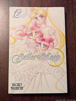 Front cover showing Sailor Moon and other characters in wedding-style dresses with pastel colors.