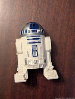Front view of white and blue Star Wars R2-D2 figure showing detailed dome and body with painted accents.
