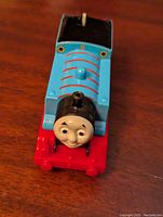 Front top view of the blue Thomas the Tank Engine battery operated toy train showing face and red base.