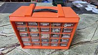 Front view of the orange RAACO organizer showing all 30 labeled drawers filled with various small hardware items.