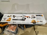 Boxed WORX 2-in-1 trimmer/edger showing product details and branding.