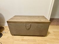 Front view of a rectangular multifunctional coffee table with a wood top and fabric storage base.