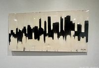 Front view of black and beige cityscape painting showing full artwork and signature