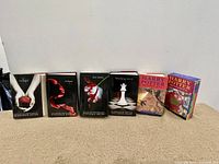 Front view of Twilight Saga hardcover set and two Harry Potter paperback books showing the cover artwork