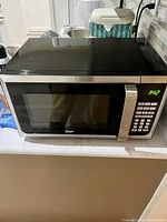 Front view of the Master Chef microwave showing the door, keypad and handle.