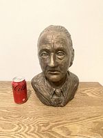 Front view of detailed bronze bust sculpture of an old man with signature and date. Coke can for size comparison.