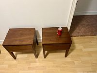 Top view of two wooden nightstands side by side with soda can for scale