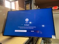 Front view of the Samsung 55 inch TV powered on showing HDMI 1 no signal screen.