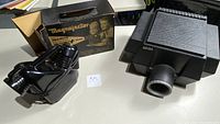 Artograph AG100 projector and Magnajector projector with box on table.