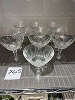 Group of 10 Baccarat coupe champagne glasses showing the set and their detailed cut crystal bowls.