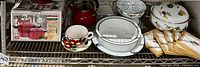 Shelf display showing the lot items including vintage Dansk Flora enamelware and assorted cookware and kitchenware