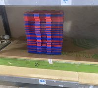 Stacked red and blue modular shelving pieces on a shelf.