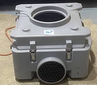 Front view of BlueDri AirShield 550 air scrubber showing round outlet with honeycomb grille and gray housing.