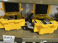 Two Invicta watches in original yellow protective cases, one leather strap and one bracelet style.