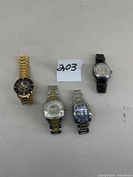 Four men’s watches displayed side by side, showing overall appearance and size