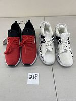 Front view of two pairs of men's size 9 sneakers, one red Nautica and one black and white Just So.