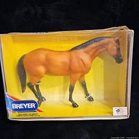 Breyer model No.450 horse figurine in original box with yellow background and clear front.