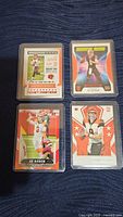 Front side of four Joe Burrow rookie cards showing player images and stats.