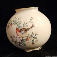 Front view of Lenox Serenade globe vase showing detailed bird perched on flowering branch design