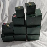 Stack of eleven green boxes containing Harmony Kingdom figures, various sizes, showing front labeling.