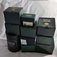 Photo of stacked green boxes with Harmony Kingdom branding, showing multiple boxed figures.