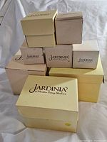 Seven Jardinia by Martin Perry Studios boxes stacked showing various box sizes and branding.