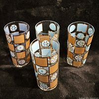 Three Culver glasses shown on black background with gold square and medallion pattern