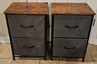Front view of two 2-drawer nightstands with fabric drawers and rustic wooden tops.
