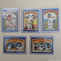 Five Topps Heritage 2021 Blue Sparkle baseball card inserts shown face-up in protective sleeves, two multi-player rookie cards included.
