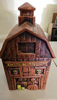 Front view of vintage McCoy Dutch barn cookie jar showing "Dutch Treat" lettering and barn details