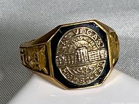 Top view showing octagonal black enamel bezel with raised Las Vegas High School seal