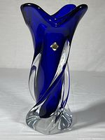 Front view of cobalt blue thick-walled glass vase with clear twist and visible original decal.
