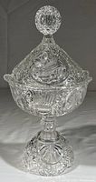 Full view of tall crystal lidded compote showing intricate cut designs and overall shape