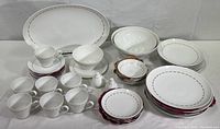 Full lot displaying all Rosenthal china pieces including plates, bowls, cups, saucers, salt and pepper shakers, and serving pieces on a white backdrop.