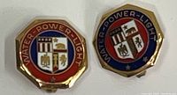 Top view of both pins showing red and blue enamel crest reading 'Water-Power-Light'.