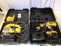 Dewalt cordless drill and orbital jigsaw in separate plastic carrying cases with cables and batteries