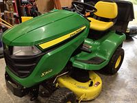 Front left angle view of mower showing hood, decals, deck.
