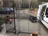 Silver and black gridwall racks side by side outdoors