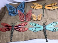 Full set of six painted metal yard art pieces shown on burlap background, including butterflies and dragonflies in blue, red, yellow, pink, and orange.
