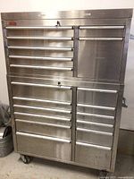 Full front view of two-section stainless steel rolling tool cabinet on caster wheels