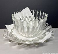 View of nested smaller and larger Studio Nova Walther glass bowls with petal edges, showing design detail and condition