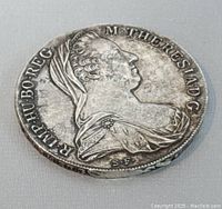 Obverse side showing profile of Empress Maria Theresa with inscription around the edge.