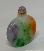 Front and side view of small jade snuff bottle showing multicolor jade material with purple, green, and orange patches.