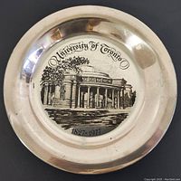 Front view of plate on black background showing etched University of Toronto Convocation Hall and inscriptions.