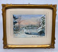 Frontal view of the gold-finished hand-carved wooden frame housing the winter landscape watercolor by Willard M. Mitchell. Signature and hanging hook visible.