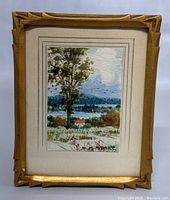 Full front view of framed watercolor landscape painting with carved wooden frame