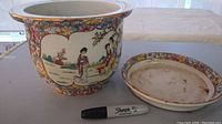 Two-piece handpainted Chinese ceramic planter set including main planter and matching saucer alongside a Sharpie for scale.